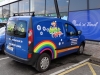 Digitally printed images and self-adhesive lettering applied to van