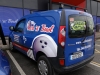 Combination of partial wrap and self-adhesive lettering on van